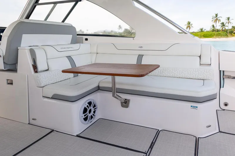 Slide: The Image of Manufacturer Provided Image: 2022 Regal LX36 boat interior with white seating and wooden table. - 34