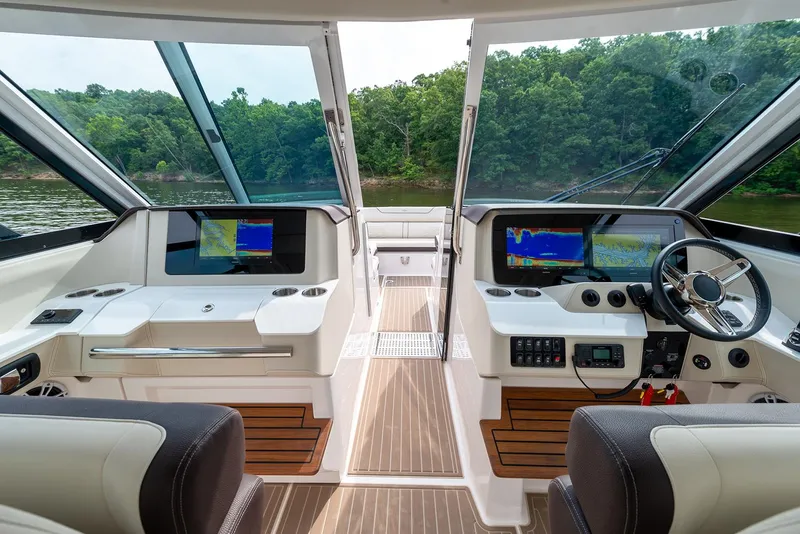 Slide: The Image of Manufacturer Provided Image: 2022 Regal LX36 boat interior with dual navigation screens and wood accents. - 35