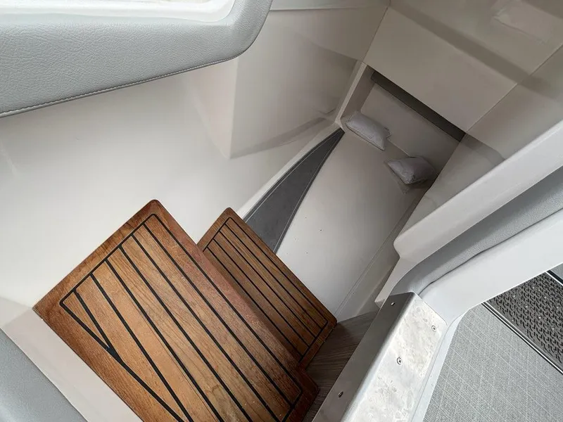 Slide: The Image of 2022 Regal LX36 cabin interior with wooden flooring and cushions. - 5