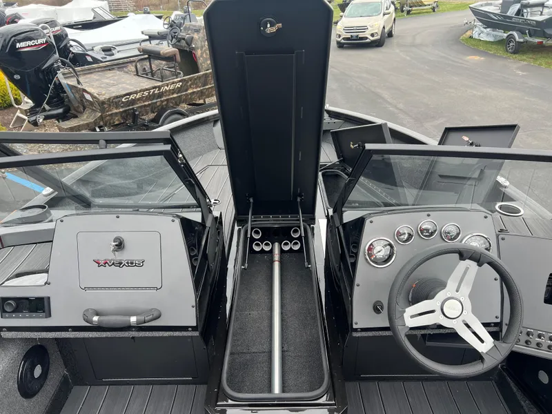 Slide: The Image of 2025 Vexus ADX 200 boat interior with steering wheel and dashboard controls. - 12