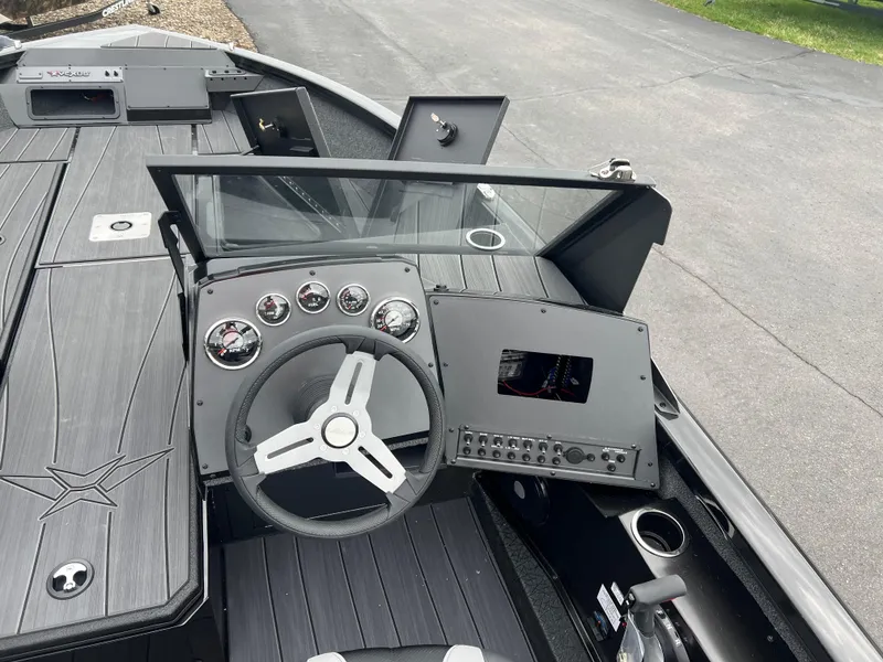 Slide: The Image of 2025 Vexus ADX 200 boat dashboard with steering wheel and control panel. - 13