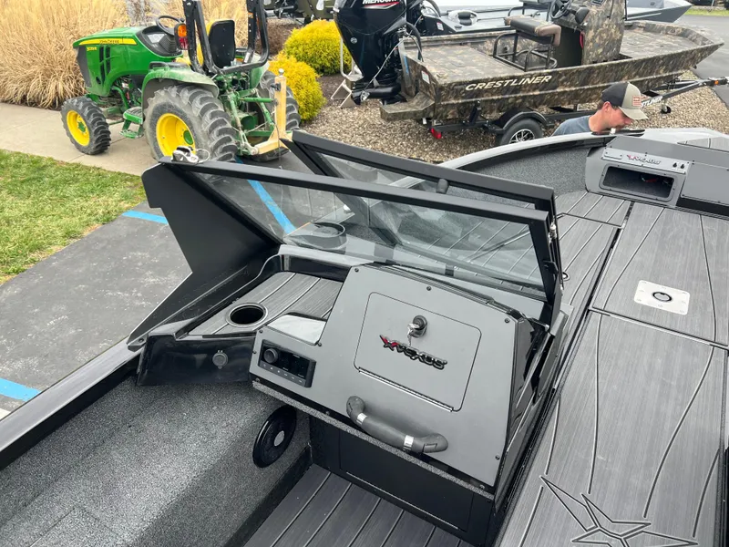 Slide: The Image of Vexus ADX 200 boat interior, 2025 model, with dashboard and seating area. - 14