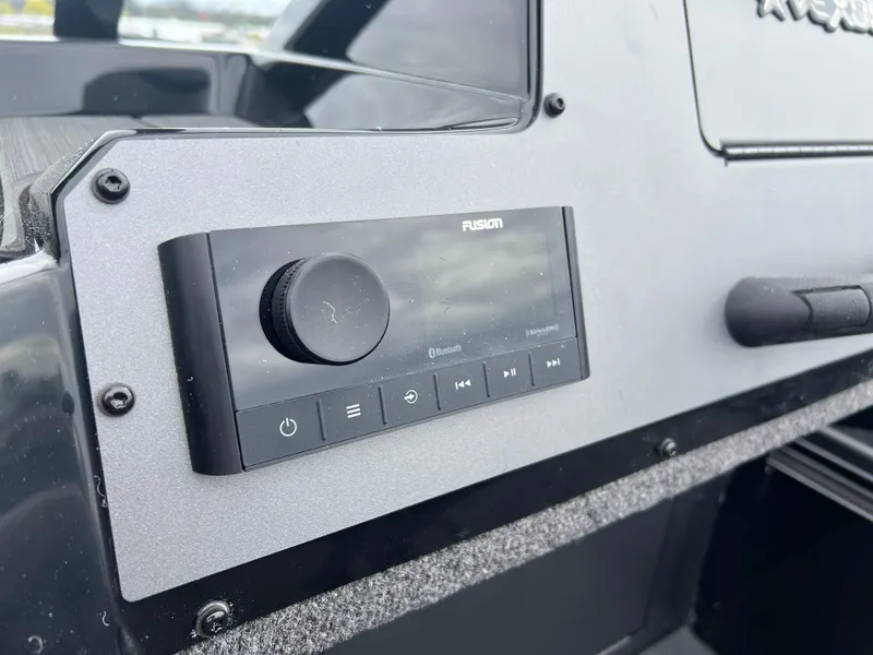 Slide: The Image of Control panel of a 2025 Vexus ADX 200 boat featuring a Fusion audio system. - 15