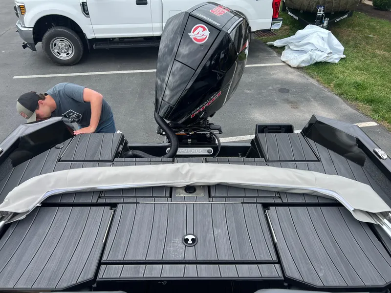 Slide: The Image of 2025 Vexus ADX 200 boat with powerful outboard motor in a parking lot. - 17