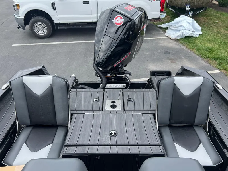 Slide: The Image of 2025 Vexus ADX 200 boat interior with dual seats and outboard motor. - 18