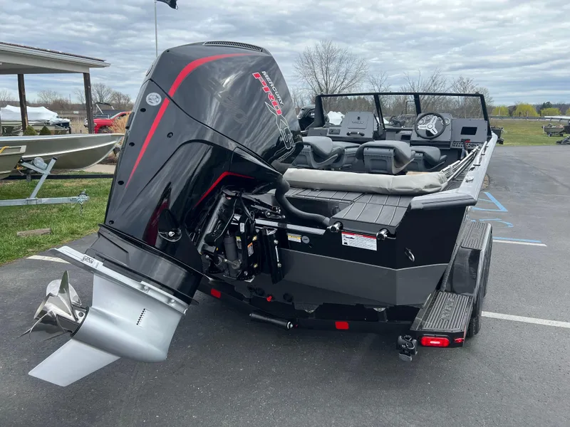 Slide: The Image of 2025 Vexus ADX 200 boat with powerful outboard motor, parked on a trailer. - 2