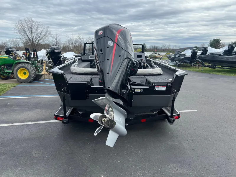 Slide: The Image of 2025 Vexus ADX 200 boat with powerful outboard motor, parked on asphalt. - 3