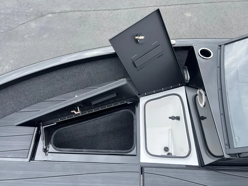 Slide: The Image of Open storage compartments on a 2025 Vexus ADX 200 boat deck. - 9