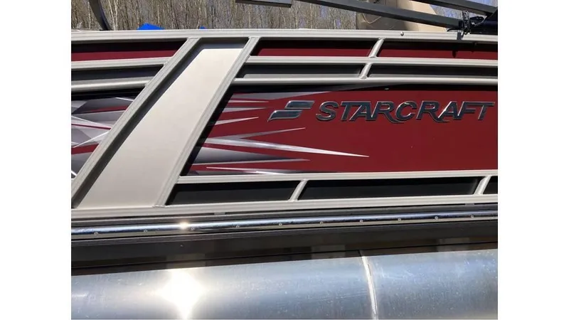 Slide: The Image of 2024 Starcraft CX 23 DL BAR boat with sleek red and silver design. - 5