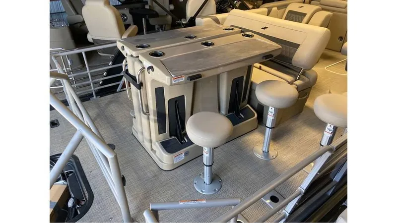 Slide: The Image of 2024 Starcraft CX 23 DL BAR interior with bar seating and table setup. - 7