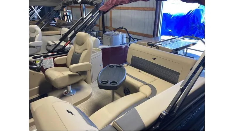 Slide: The Image of 2024 Starcraft CX 23 DL BAR pontoon boat interior with beige seating and table. - 9