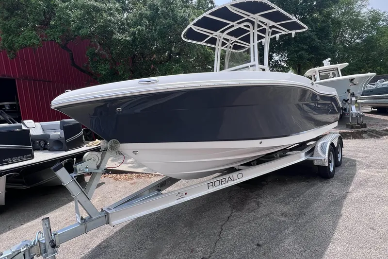 The Image of 2024 Robalo R200 Center Console boat on trailer, parked outdoors. - 0