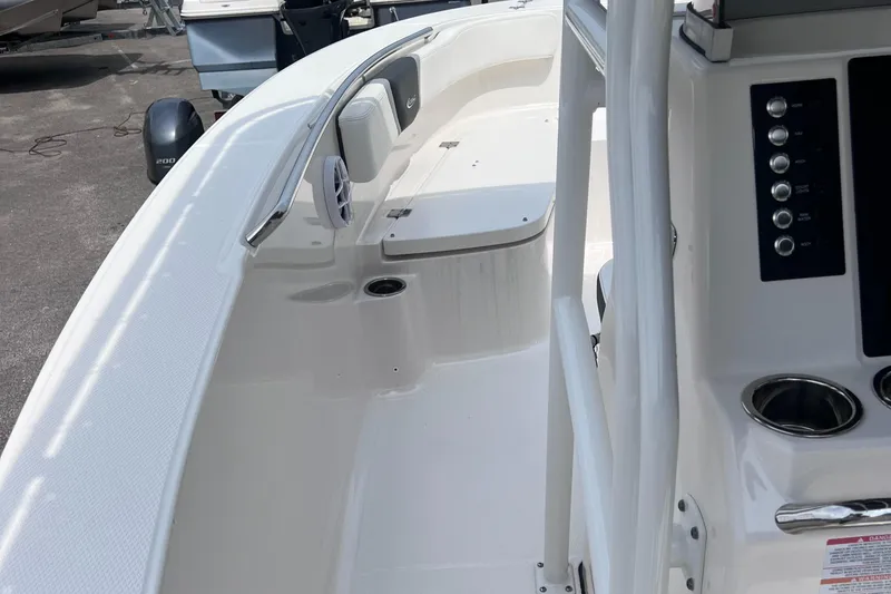 Slide: The Image of 2024 Robalo R200 Center Console boat interior with seating and control panel. - 12