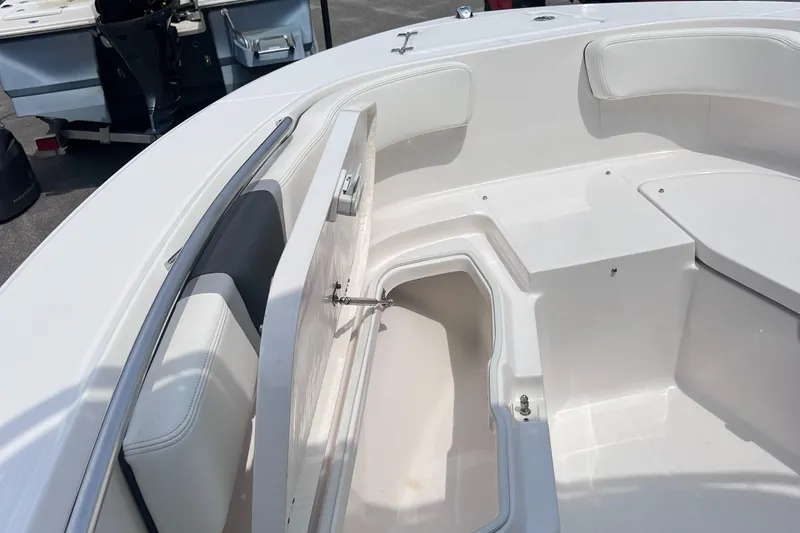 Slide: The Image of 2024 Robalo R200 Center Console boat with open storage compartment. - 13