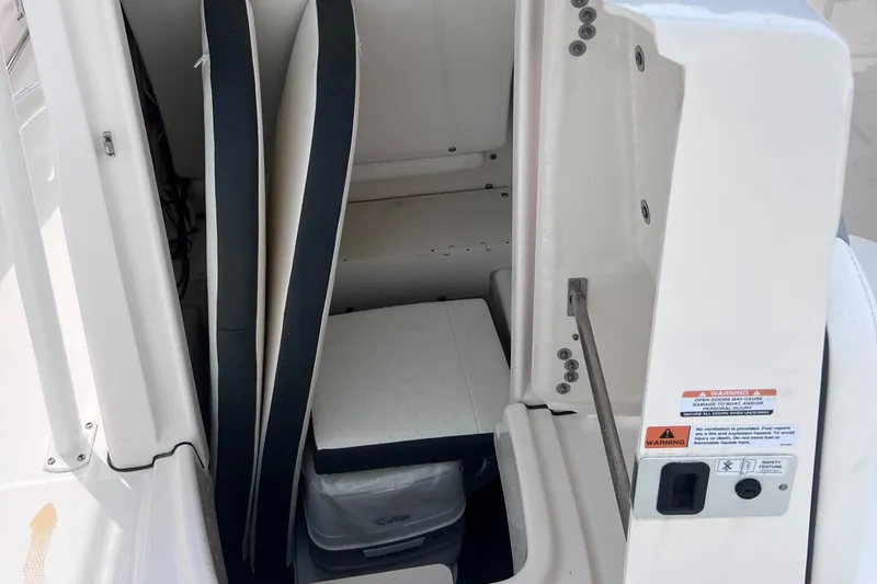 Slide: The Image of 2024 Robalo R200 Center Console storage compartment with cushions and cooler. - 15