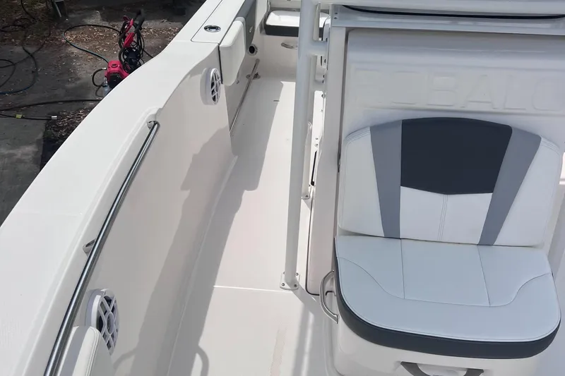 Slide: The Image of 2024 Robalo R200 Center Console boat interior with cushioned seating and sleek design. - 17