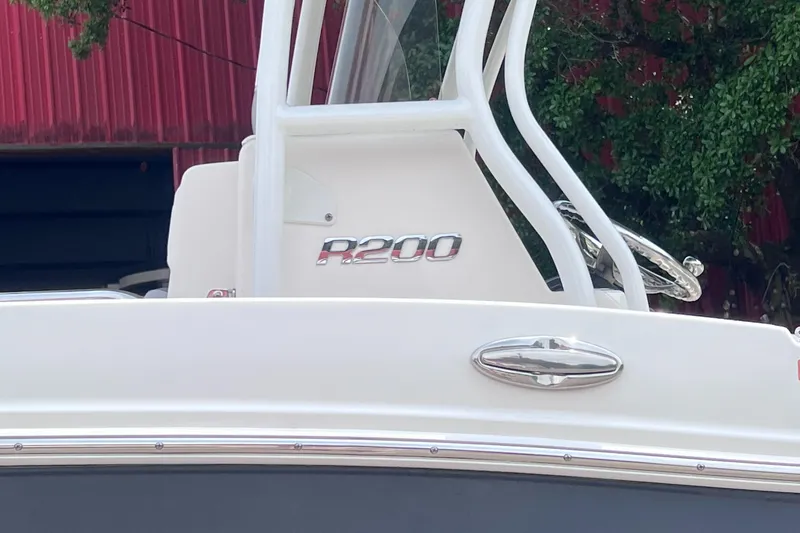 Slide: The Image of 2024 Robalo R200 Center Console boat with sleek design and chrome details. - 19