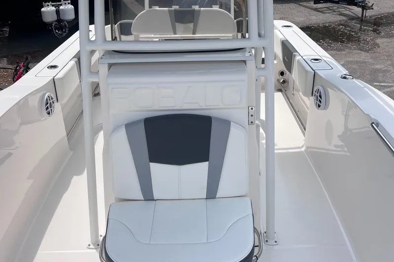 Slide: The Image of 2024 Robalo R200 Center Console boat interior with white and gray seating. - 2