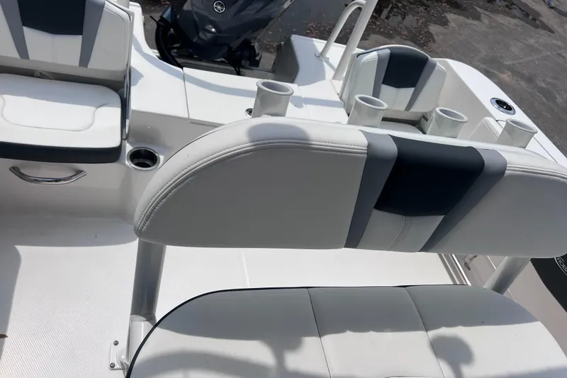 Slide: The Image of 2024 Robalo R200 Center Console boat interior with seating and cup holders. - 9
