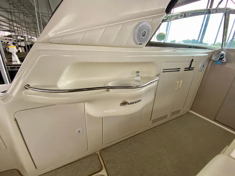 Slide: The Image of 1999 Sea Ray 400 Sundancer interior with sink and storage cabinets. - 11