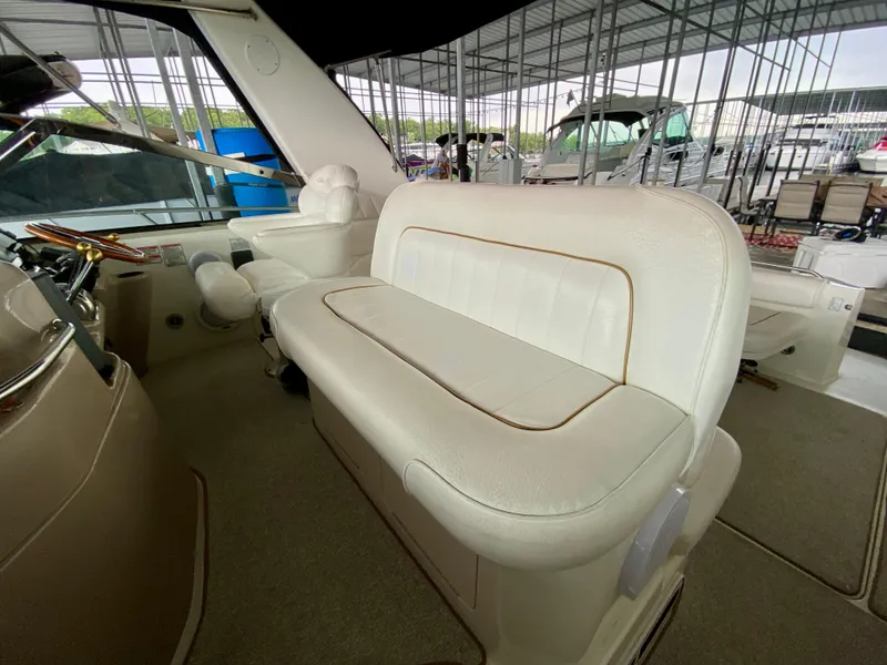 Slide: The Image of Interior of a 1999 Sea Ray 400 Sundancer yacht with white leather seating. - 12