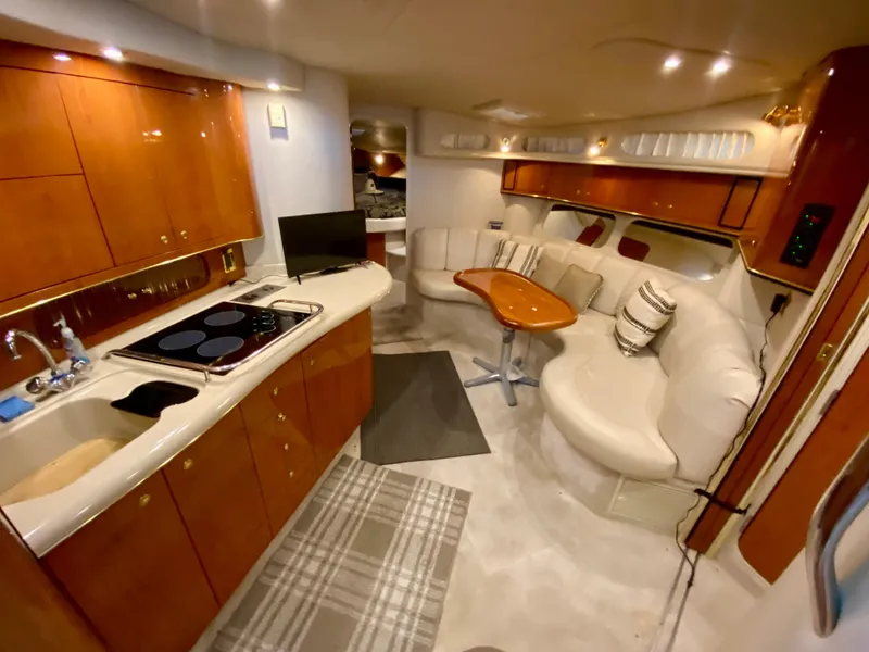 Slide: The Image of Luxurious interior of a 1999 Sea Ray 400 Sundancer yacht with kitchen and seating area. - 18