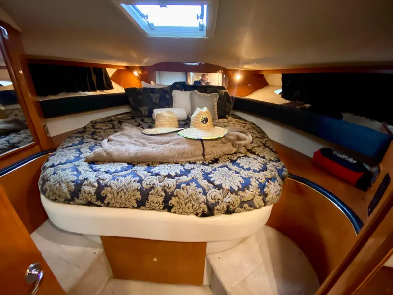 Slide: The Image of Luxurious cabin interior of 1999 Sea Ray 400 Sundancer yacht with elegant bedding. - 21