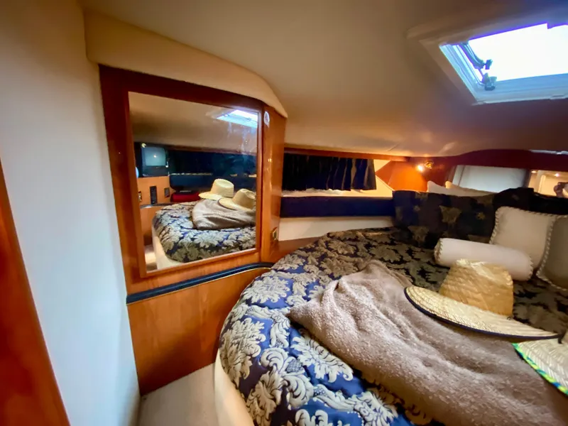 Slide: The Image of Luxurious cabin interior of 1999 Sea Ray 400 Sundancer yacht with elegant bedding. - 23
