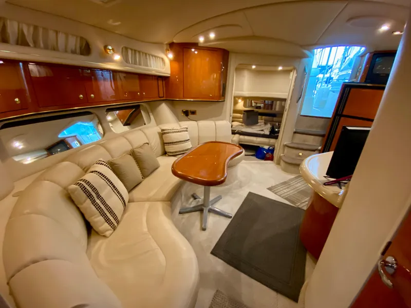 Slide: The Image of Luxurious interior of a 1999 Sea Ray 400 Sundancer yacht with plush seating and elegant wood finishes. - 24