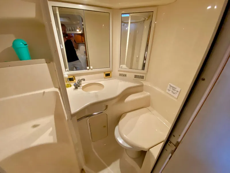 Slide: The Image of Bathroom interior of 1999 Sea Ray 400 Sundancer yacht, featuring sink and toilet. - 25