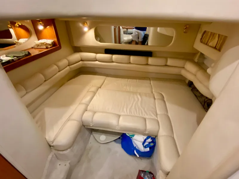 Slide: The Image of Interior of 1999 Sea Ray 400 Sundancer yacht with beige seating and cozy lighting. - 28
