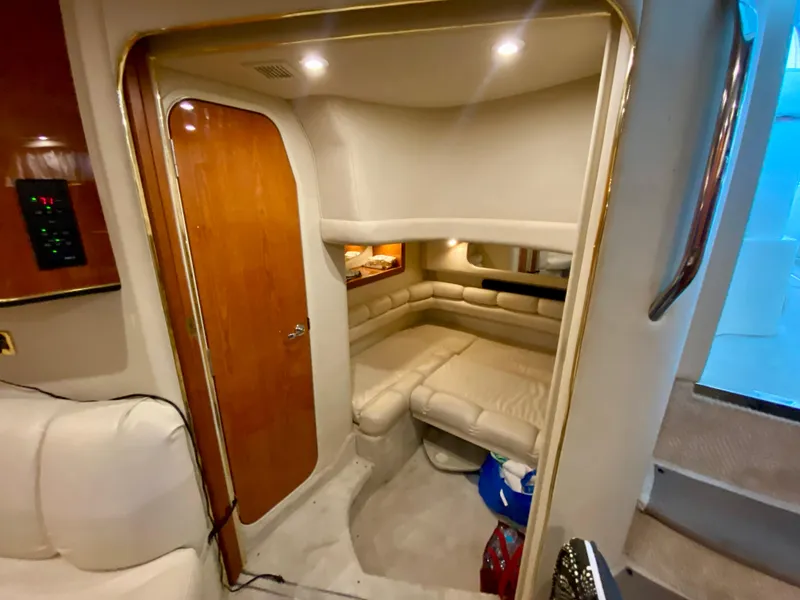Slide: The Image of Interior cabin of 1999 Sea Ray 400 Sundancer yacht with cozy seating and wooden door. - 29