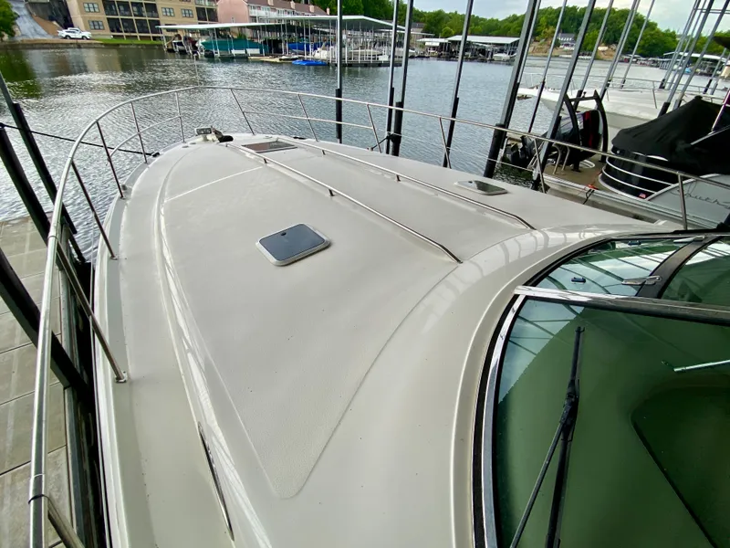 Slide: The Image of 1999 Sea Ray 400 Sundancer yacht docked at marina, showcasing sleek deck design. - 3