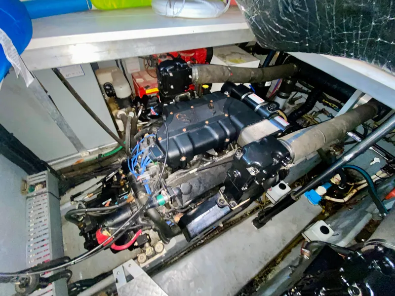 Slide: The Image of Engine compartment of a 1999 Sea Ray 400 Sundancer boat, showcasing mechanical components. - 31