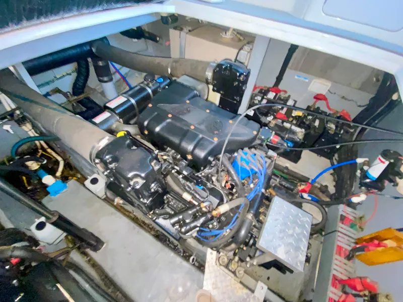 Slide: The Image of Engine compartment of a 1999 Sea Ray 400 Sundancer boat, showcasing mechanical components. - 32