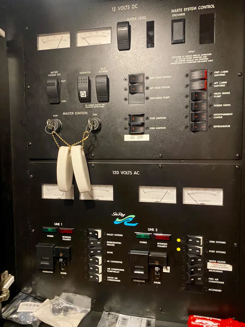 Slide: The Image of Control panel of a 1999 Sea Ray 400 Sundancer boat, showing electrical switches and gauges. - 34