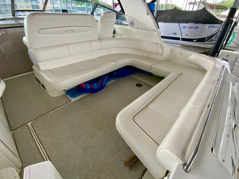 Slide: The Image of 1999 Sea Ray 400 Sundancer interior with spacious white seating area. - 8