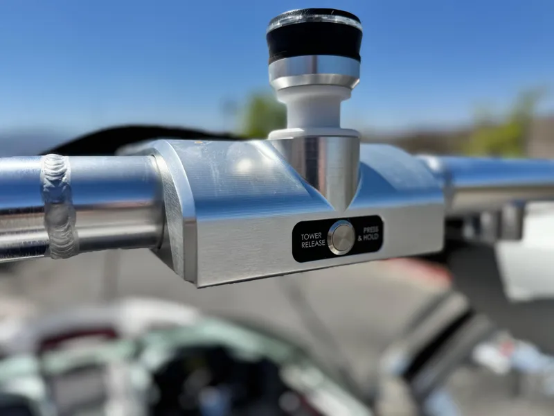 Slide: The Image of Close-up of 2022 MasterCraft XStar S tower release mechanism under clear blue sky. - 17