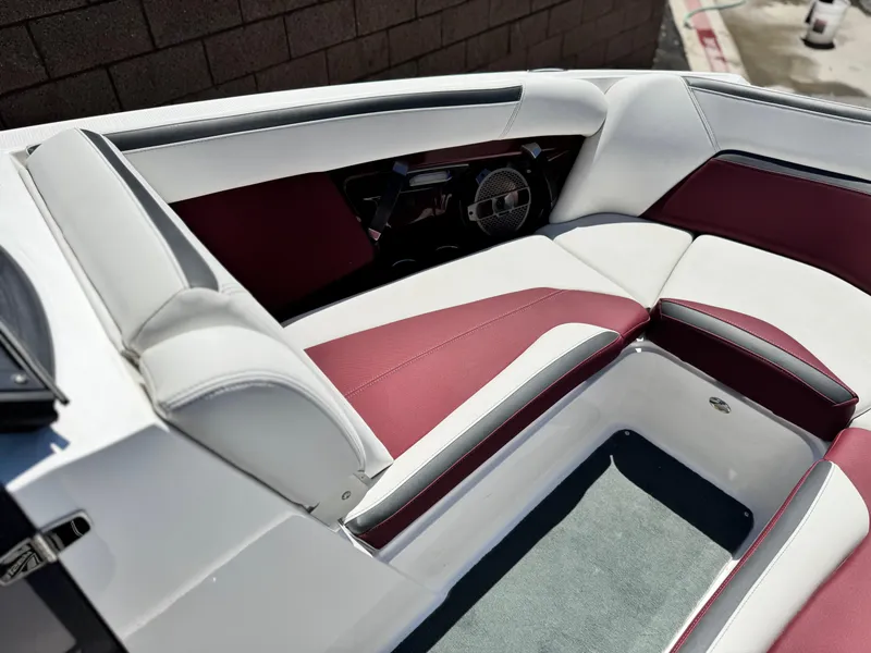 Slide: The Image of 2022 MasterCraft XStar S boat interior with red and white seating, showcasing luxury design. - 19