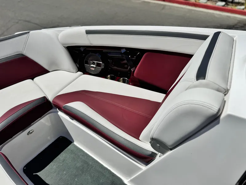 Slide: The Image of 2022 MasterCraft XStar S interior with white and maroon seating, featuring sleek design and premium materials. - 20