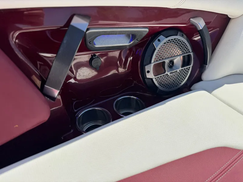 Slide: The Image of Interior of 2022 MasterCraft XStar S with speaker, cup holders, and maroon accents. - 21