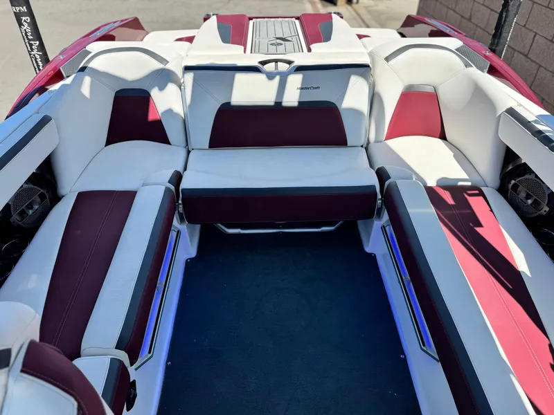 Slide: The Image of 2022 MasterCraft XStar S interior with red and white seating, showcasing luxury design. - 23