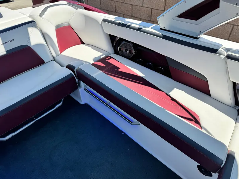 Slide: The Image of 2022 MasterCraft XStar S interior with white and maroon seating, showcasing luxury design. - 27