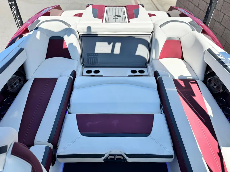 Slide: The Image of 2022 MasterCraft XStar S interior with white and maroon seating, cup holders, and sleek design. - 30