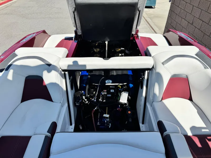 Slide: The Image of 2022 MasterCraft XStar S boat engine compartment with open hatch, showcasing interior components. - 32