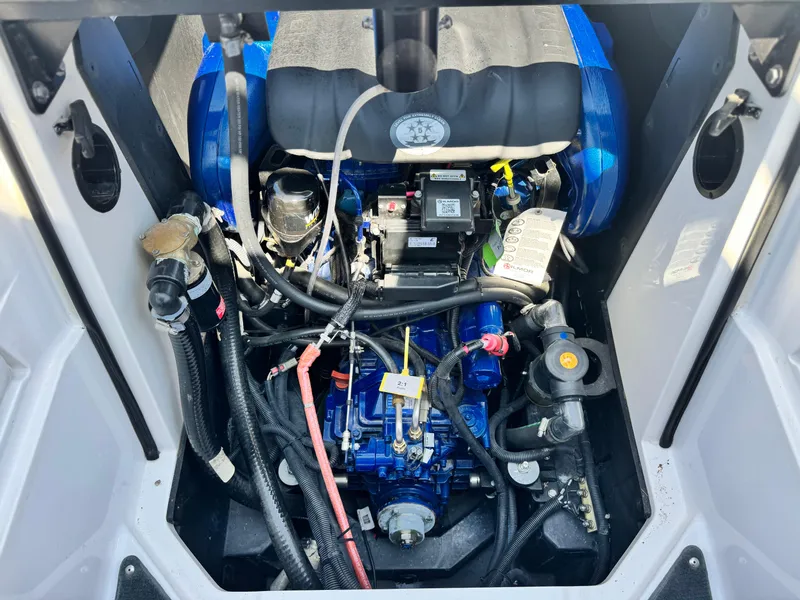 Slide: The Image of 2022 MasterCraft XStar S engine compartment with visible components and wiring. - 33