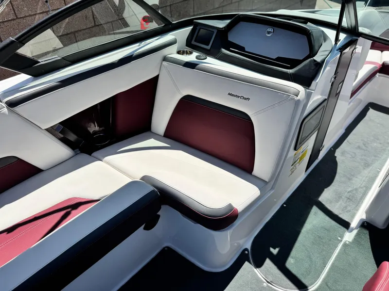 Slide: The Image of 2022 MasterCraft XStar S interior with white and maroon seating, sleek dashboard design. - 35