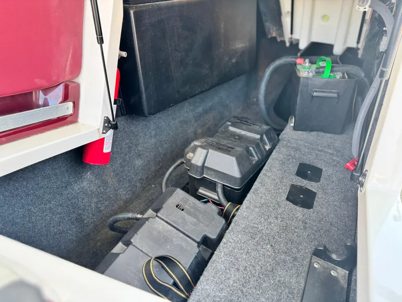 Slide: The Image of Interior storage compartment of 2022 MasterCraft XStar S boat with battery and fire extinguisher. - 37