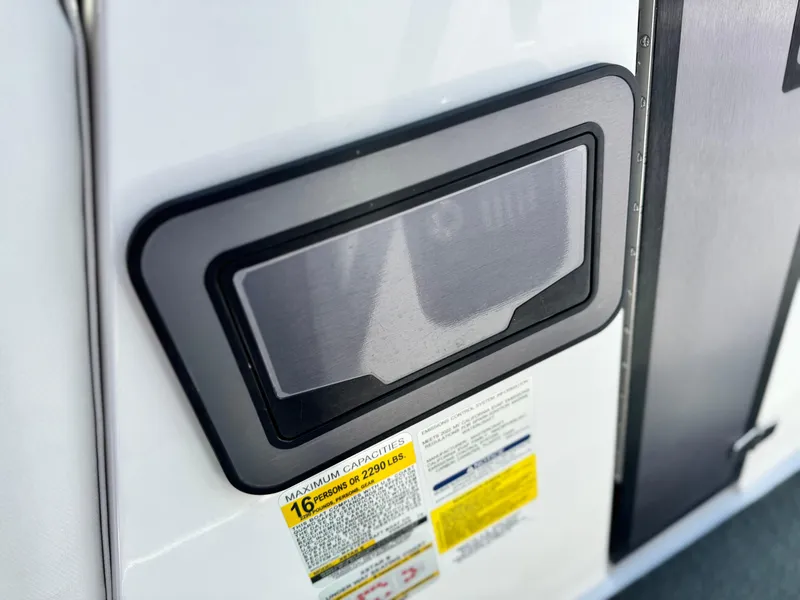 Slide: The Image of 2022 MasterCraft XStar S boat capacity label and storage compartment detail. - 38