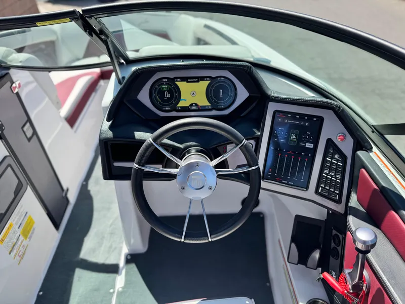 Slide: The Image of 2022 MasterCraft XStar S boat dashboard with modern controls and steering wheel. - 40